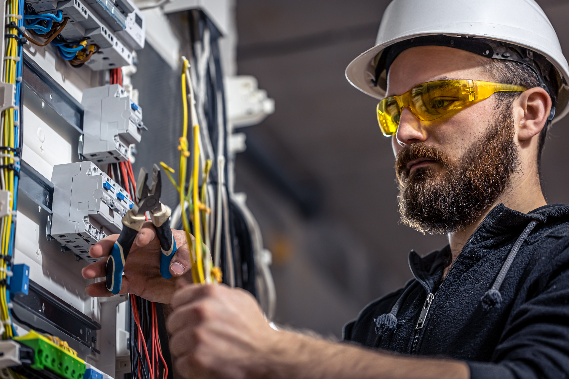 Licensed IT technician installing enterprise network cabling and conference room technology in a commercial office building